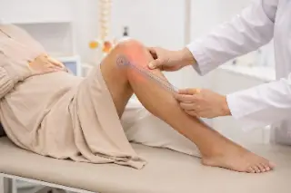 Physiotherapist Measuring Knee Joint Range of Motion Using Goniometer - Orthopedic Exam Photo