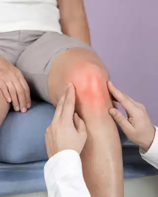 Physician Examining Patient Patella Knee Joint - Orthopedic Assessment Photo