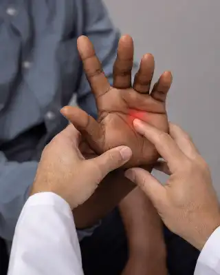 Doctor Examining Patient Palm for Trigger Finger Pain - Orthopedic Exam Photo