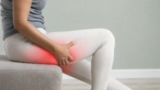 Patient Experiencing Severe Leg Nerve Pain and Thigh Muscle Discomfort - Stock Photo