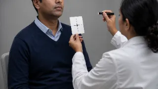 Neurologist Performing Cranial Nerve Examination on Patient in Clinic