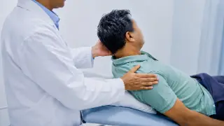 Doctor Performing Dix-Hallpike Maneuver for Positional Vertigo Diagnosis