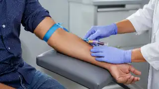 Medical Professional Drawing Blood Sample from Adult Patient Arm Stock Photo