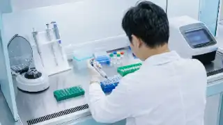 Scientist Using Pipette in PCR Laboratory - Molecular Biology Stock Photo