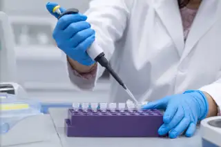 Laboratory Technician Preparing PCR Samples with Pipette - Clinical Research Stock Photo