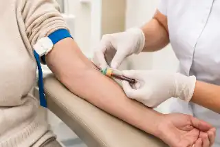 Senior Patient Having Blood Drawn By Healthcare Worker in Clinical Setting