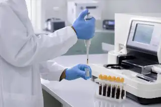Medical Laboratory Technician Performing Kidney Testing Workflow Analysis - Stock Photo