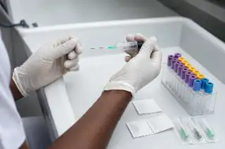 Medical Professional Preparing Blood Collection Needle in Clinic